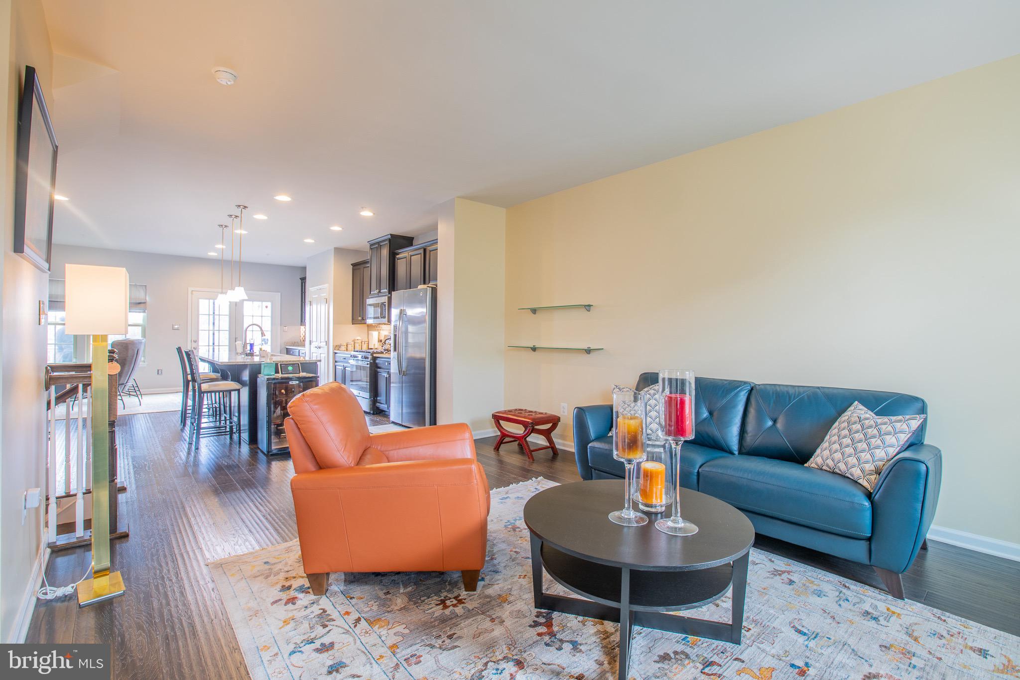 2608 Fiat Drive Hanover, MD 21076 - Photo 10 of 39 a living room with furniture and a dining table with wooden floor
