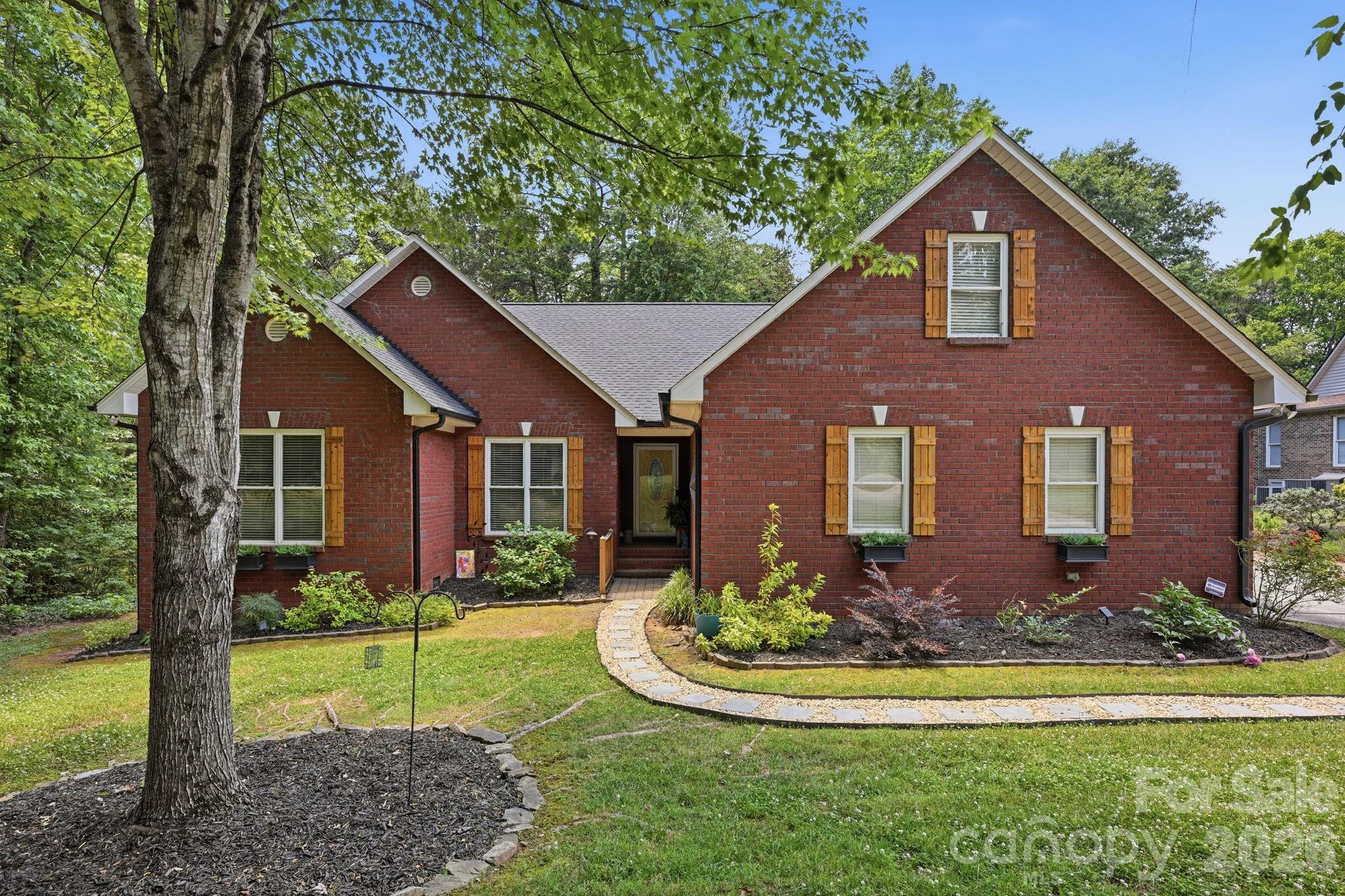145 Upper Spencer Mountain Road Stanley, NC 28164 - Photo 1 of 29 a front view of house with yard and green space