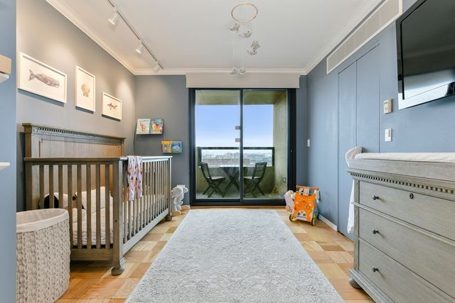a view of a hallway with a window and furniture
