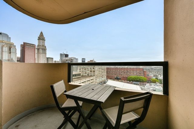 a view of a balcony with an outdoor seating