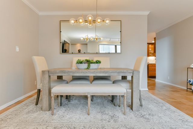 a view of a dining room with furniture and chandelier