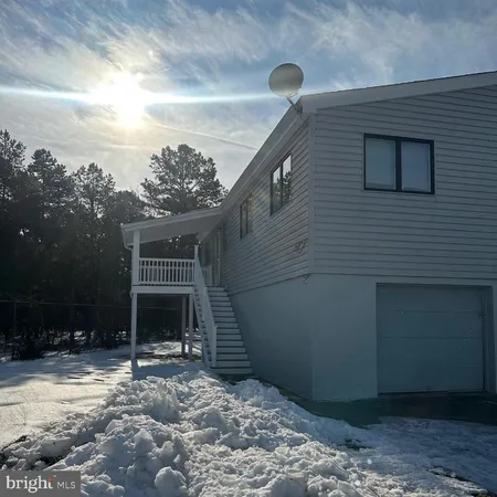 a backyard of a house with plants and trees