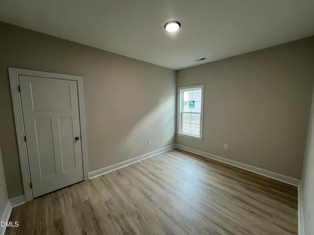 a view of an empty room and wooden floor