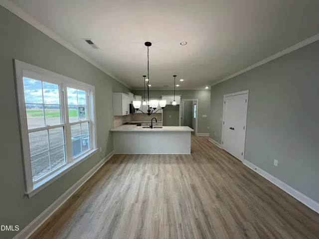 a view of a kitchen with a sink stainless steel appliances and cabinets
