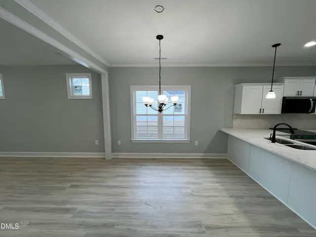 a view with a sink a counter space and a window