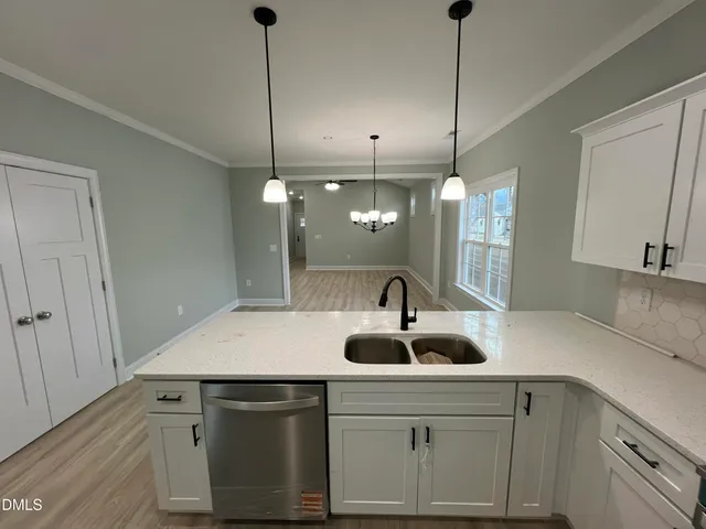 a kitchen with white cabinets and a stove top oven