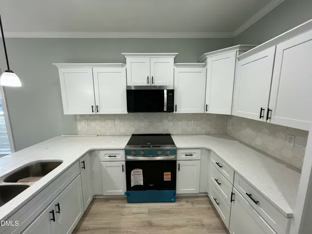 a kitchen with granite countertop a stove and a refrigerator