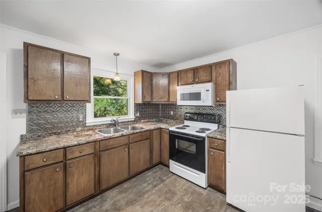 a kitchen with a sink stove and refrigerator