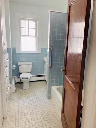 52 Powder House Boulevard, Unit 1 Somerville, MA 02144 - Photo 13 of 30 a bathroom with a toilet and a shower