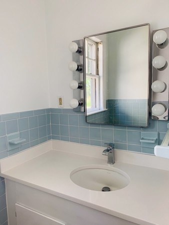 52 Powder House Boulevard, Unit 1 Somerville, MA 02144 - Photo 14 of 30 a bathroom with a sink and a bathtub