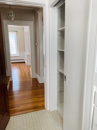 52 Powder House Boulevard, Unit 1 Somerville, MA 02144 - Photo 15 of 30 a view of a hallway with wooden floor and closet