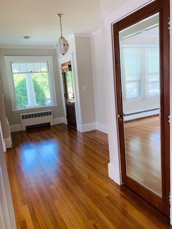 52 Powder House Boulevard, Unit 1 Somerville, MA 02144 - Photo 16 of 30 a view of an entryway with wooden floor and door
