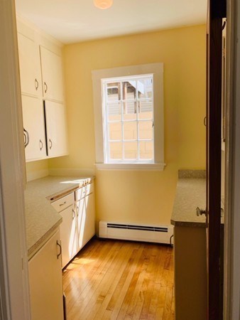 52 Powder House Boulevard, Unit 1 Somerville, MA 02144 - Photo 19 of 30 a view of a kitchen with a sink and dishwasher
