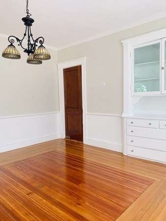 52 Powder House Boulevard, Unit 1 Somerville, MA 02144 - Photo 20 of 30 a view of a room with wooden floor and cabinet