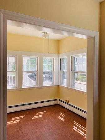 52 Powder House Boulevard, Unit 1 Somerville, MA 02144 - Photo 22 of 30 a view of an empty room with a window