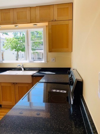 52 Powder House Boulevard, Unit 1 Somerville, MA 02144 - Photo 24 of 30 a room with pool table and a window