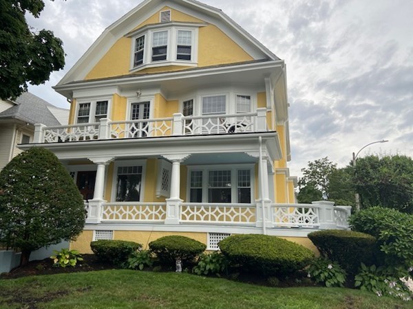 52 Powder House Boulevard, Unit 1 Somerville, MA 02144 - Photo 3 of 30 a front view of a house with a yard