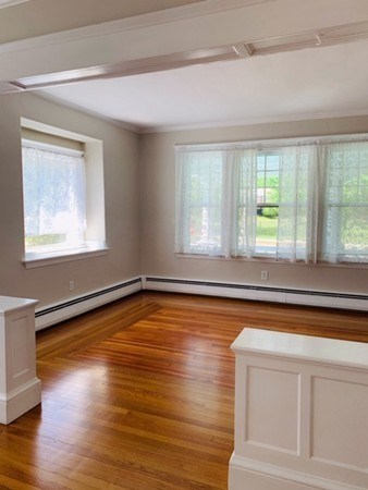 52 Powder House Boulevard, Unit 1 Somerville, MA 02144 - Photo 6 of 30 a view of empty room with wooden floor and fan