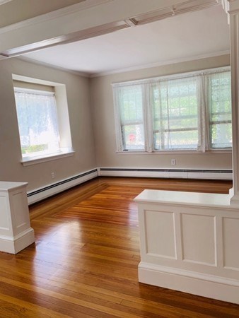 52 Powder House Boulevard, Unit 1 Somerville, MA 02144 - Photo 8 of 30 a view of a room with wooden floor and a window