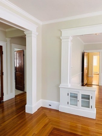 52 Powder House Boulevard, Unit 1 Somerville, MA 02144 - Photo 9 of 30 a view of an empty room with wooden floor and a window