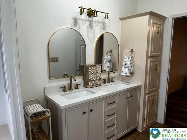 a bathroom with a double vanity sink and a mirror