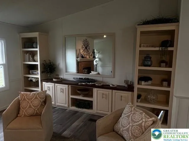 a living room with furniture and a kitchen