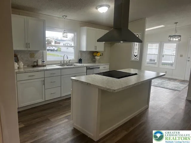a kitchen with a sink a stove and cabinets