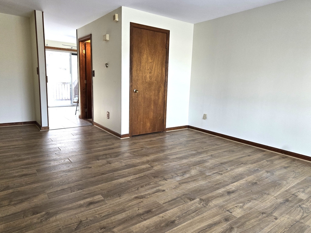 1170 Wilson Road, Unit 1 Fall River, MA 02720 - Photo 11 of 25 a view of an empty room with wooden floor and a window