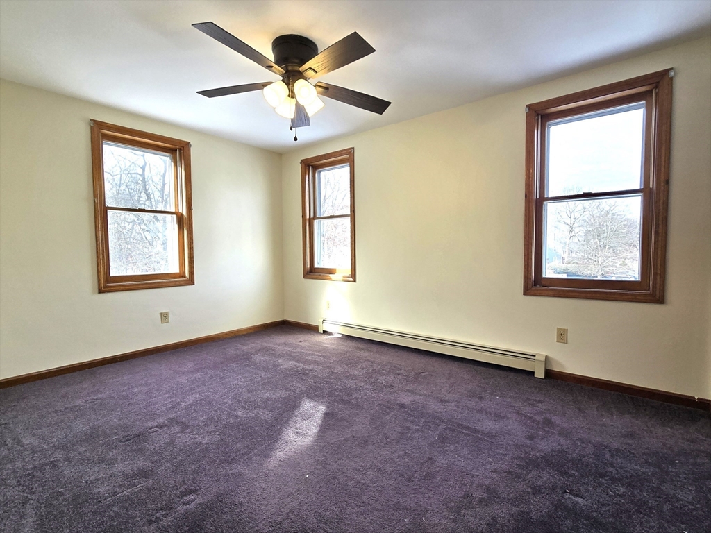 1170 Wilson Road, Unit 1 Fall River, MA 02720 - Photo 16 of 25 an empty room with windows and ceiling fan