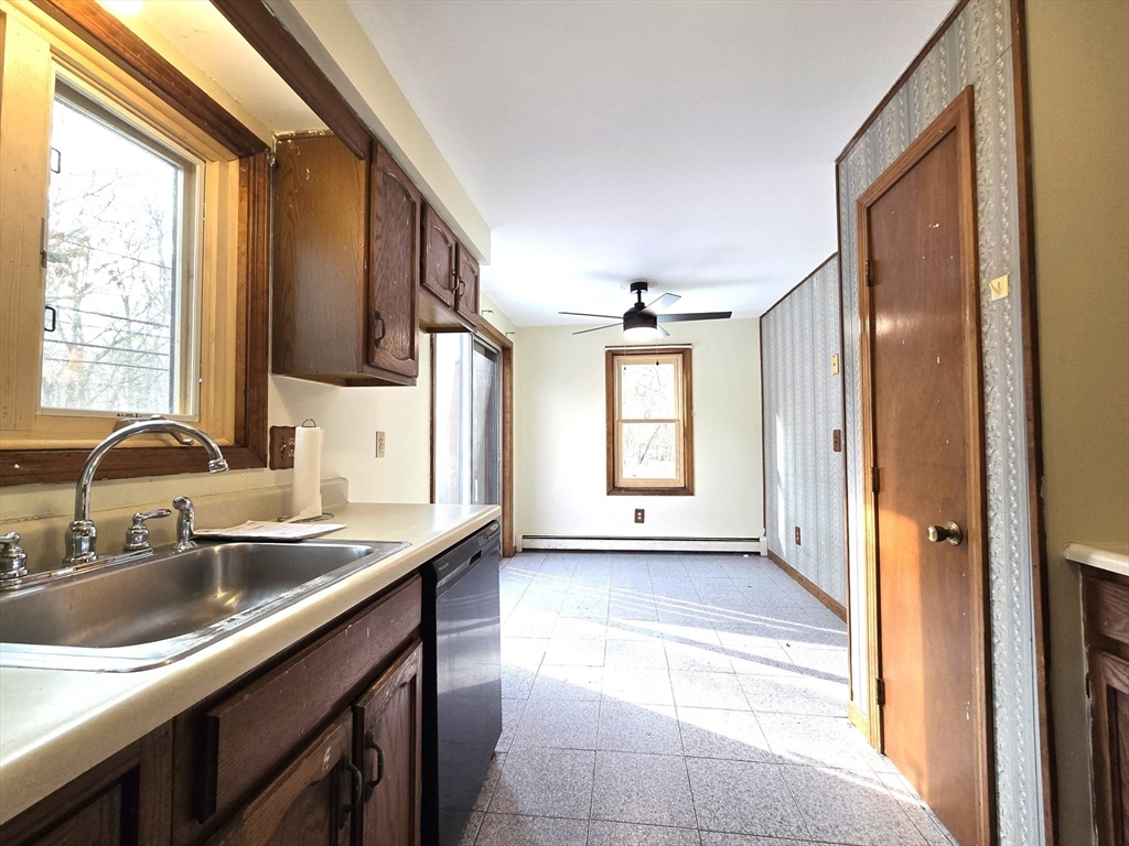 1170 Wilson Road, Unit 1 Fall River, MA 02720 - Photo 5 of 25 a kitchen with stainless steel appliances granite countertop a sink and a large window