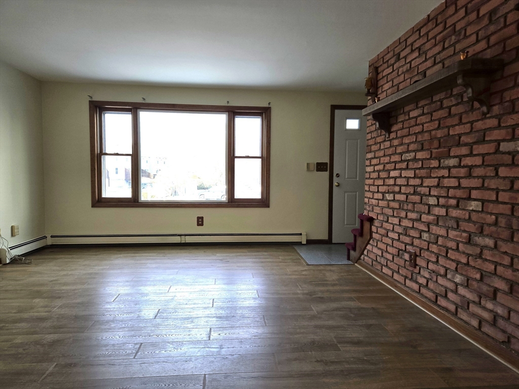 1170 Wilson Road, Unit 1 Fall River, MA 02720 - Photo 8 of 25 an empty room with wooden floor and windows