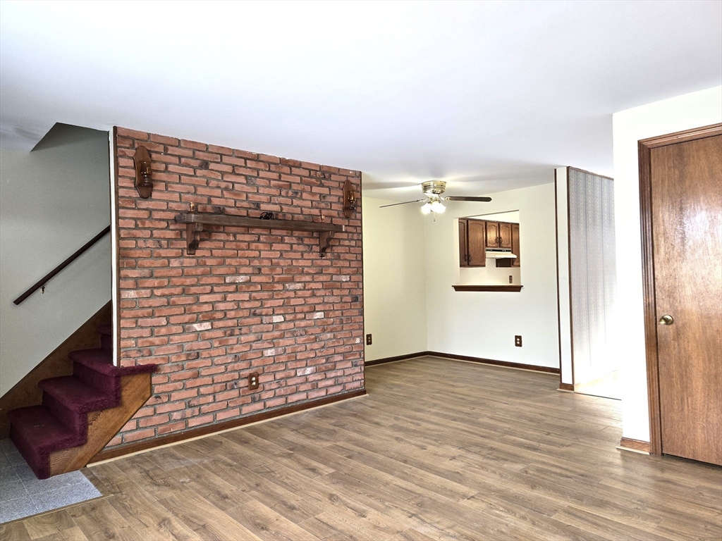 1170 Wilson Road, Unit 1 Fall River, MA 02720 - Photo 9 of 25 a view of an empty room with wooden floor and a window