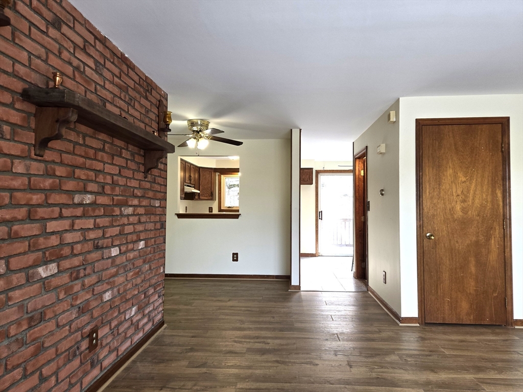 1170 Wilson Road, Unit 1 Fall River, MA 02720 - Photo 10 of 25 a view of a hallway with wooden floor and brick wall