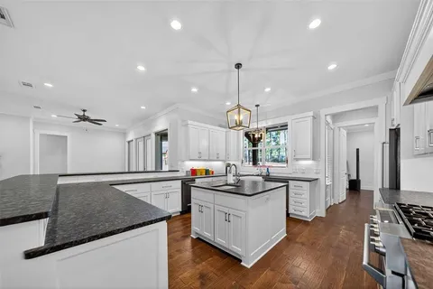 a kitchen with stainless steel appliances granite countertop a sink stove and refrigerator