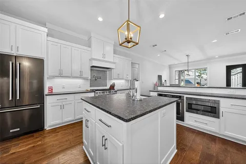 a kitchen with cabinets and stainless steel appliances