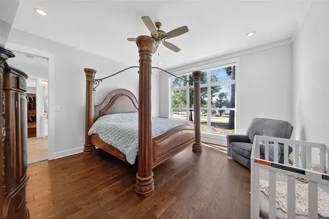 a bedroom with furniture window and a ceiling fan