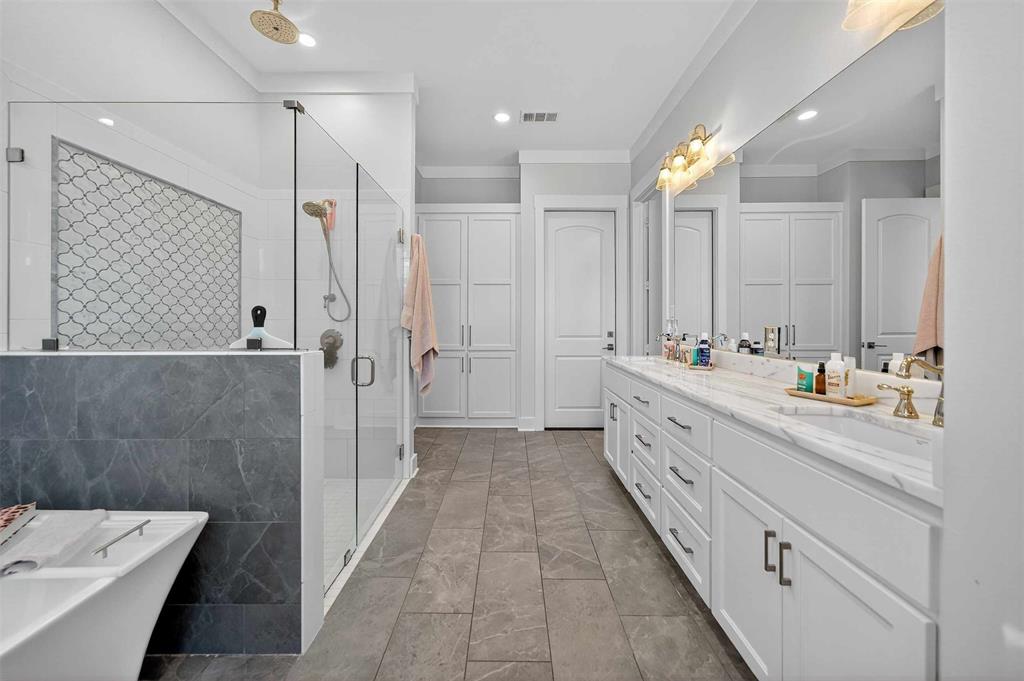 22227 Mallards Cove Bullard, TX 75757 - Photo 24 of 39 a bathroom with a double vanity sink a large mirror and shower