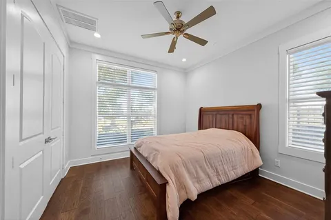 a bedroom with a large bed and a window