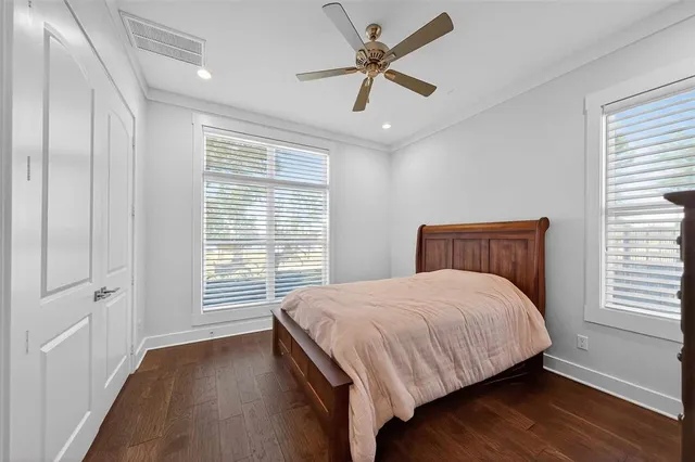 a bedroom with a large bed and a window