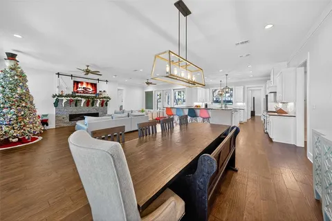 a living room with fireplace furniture and a wooden floor