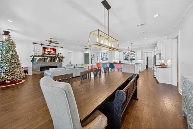 a living room with fireplace furniture and a wooden floor