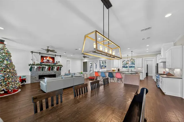 a living room with lots of furniture and kitchen view
