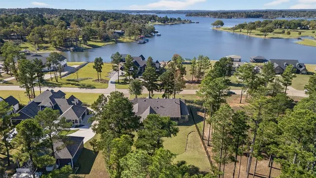 an aerial view of lake and residential houses with outdoor space