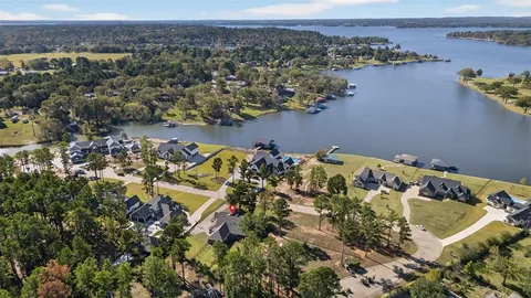 an aerial view of a house with a yard and ocean view
