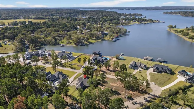 an aerial view of a house with a yard and ocean view