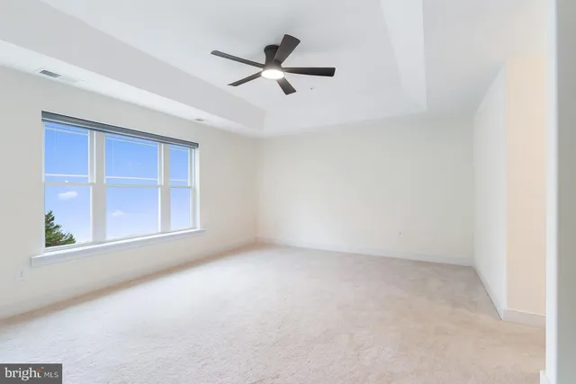 an empty room with a empty space and windows