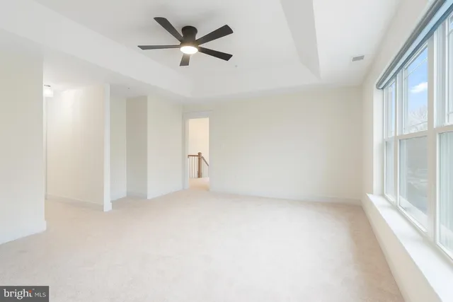 an empty room with a empty space and a ceiling fan