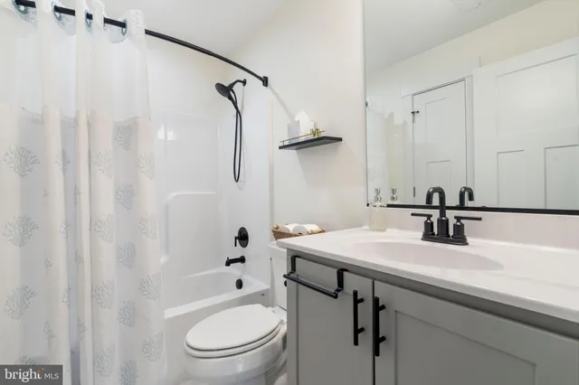 a bathroom with a sink toilet tub and shower