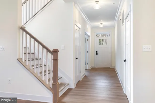 a view of a hallway with wooden floor and entryway