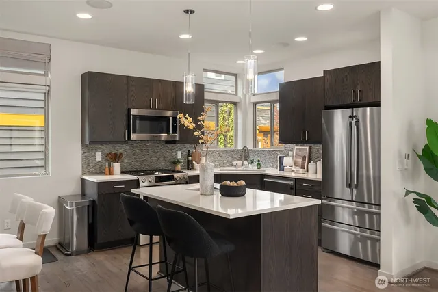 a living room with kitchen island furniture and a kitchen view